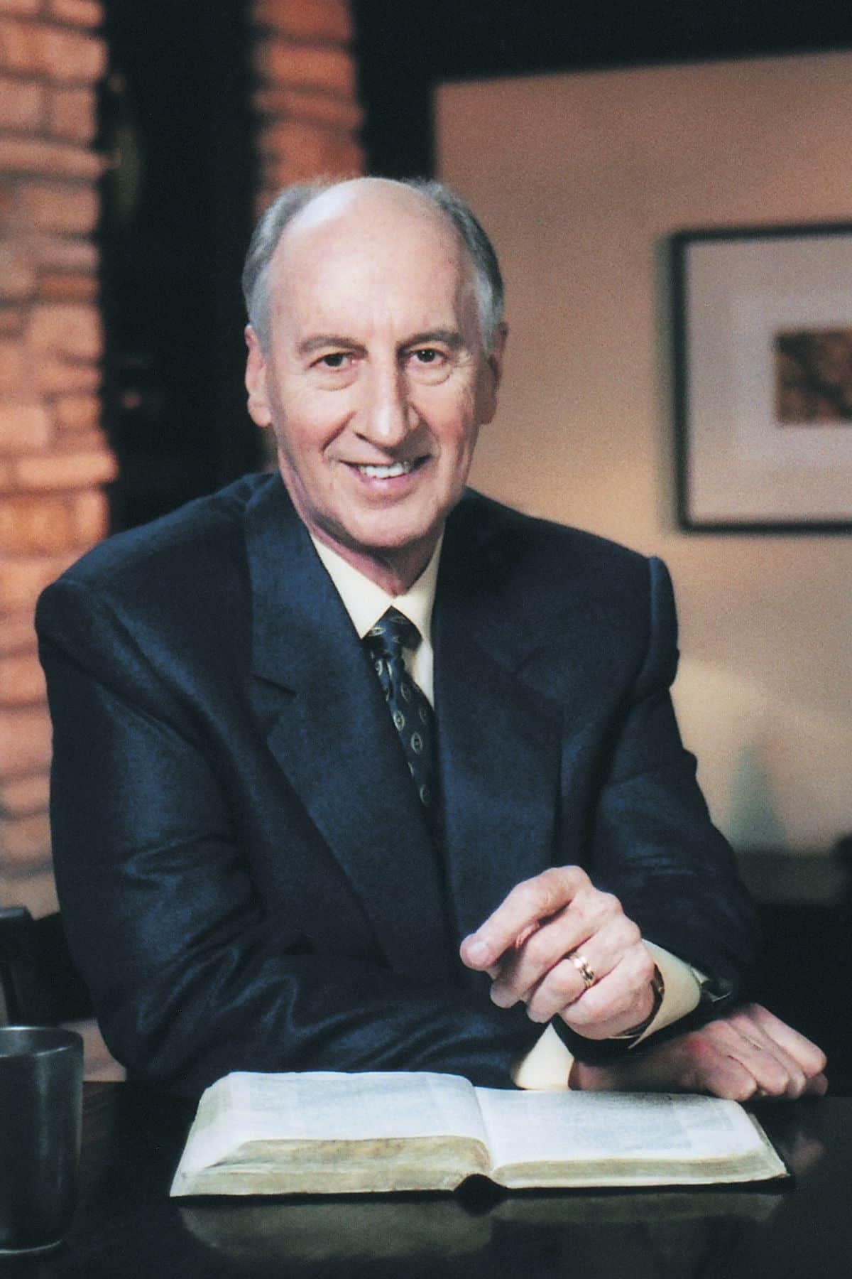 Pastor Jack Hayford seated with an open Bible